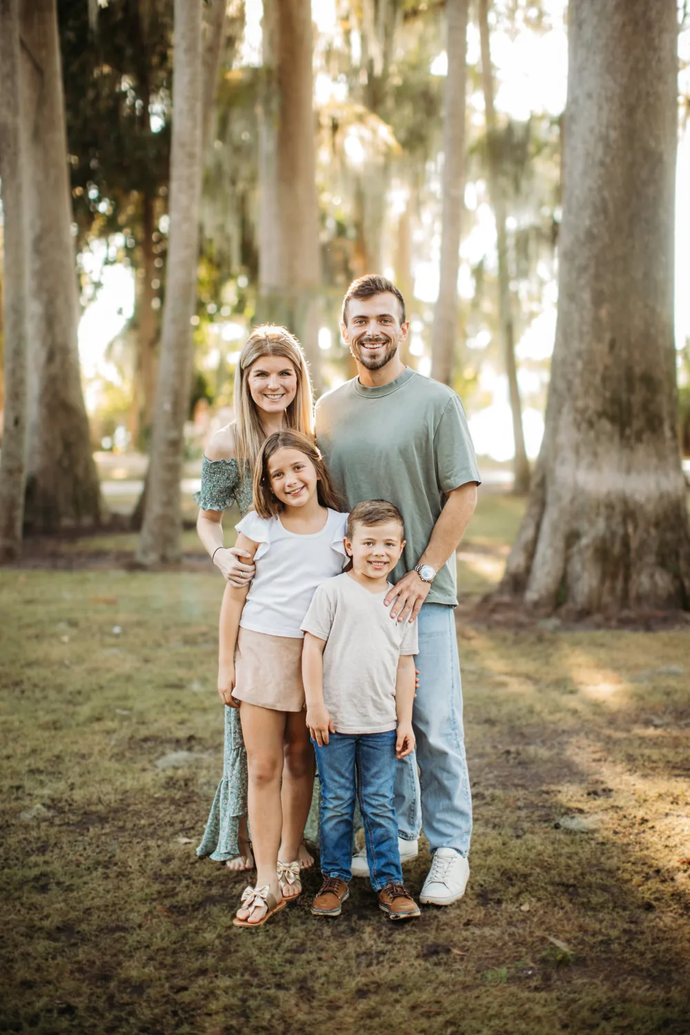 Ross Pino with his wife, daughter and son under the trees